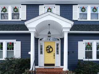 Blue home with 5 new windows and a yellow door