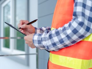 Photo Of Contractor Checking Off Items For Inspection